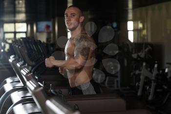 Handsome Man Running On The Treadmill In Gym