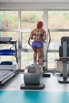 Fitness Girl Exercising On Moonwalker Treadmill In A Modern Fitness Center