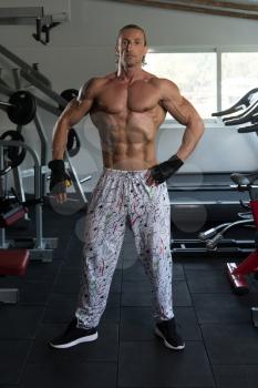 Portrait Of A Mature Physically Fit Tattoo Man Showing His Well Trained Body - Muscular Athletic Bodybuilder Fitness Model Posing After Exercises