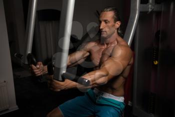 Handsome Athlete Doing Heavy Weight Exercise For Chest On Machine
