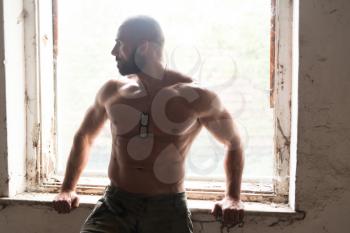 Portrait of a Physically Fit Man Showing His Well Trained Body - Muscular Athletic Bodybuilder Fitness Man Posing After Exercises Inside Refuge