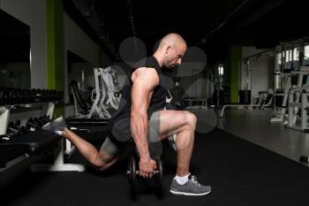 Strong Man In The Gym Exercising Quadriceps And Glutes With Dumbbells - Muscular Athletic Bodybuilder Fitness Model Exercise