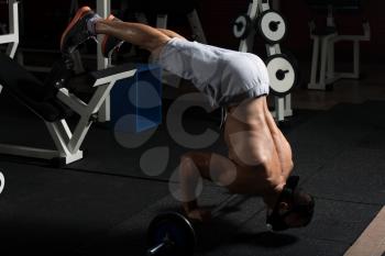 Bodybuilder Doing Push Ups On Barbell As Part Of Bodybuilding Training In Elevation Mask