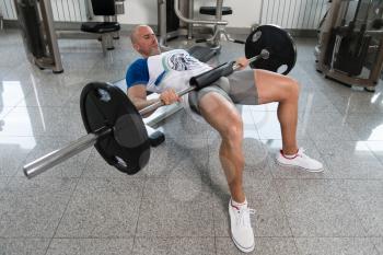 Strong Man In The Gym Exercising Legs With Barbell - Muscular Athletic Bodybuilder Fitness Model Exercise