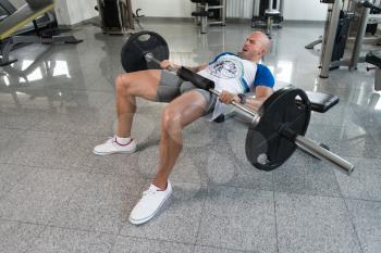 Strong Man In The Gym Exercising Quadriceps And Glutes With Barbell - Muscular Athletic Bodybuilder Fitness Model Exercise