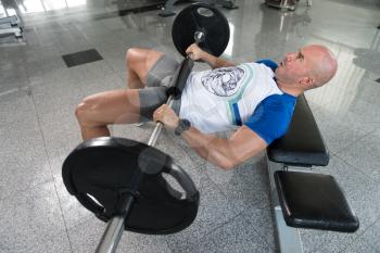 Strong Man In The Gym Exercising Hamstrings With Barbell - Muscular Athletic Bodybuilder Fitness Model Exercise