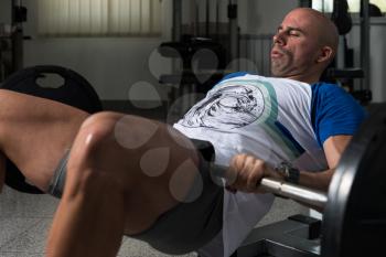 Strong Man In The Gym Exercising Hamstrings With Barbell - Muscular Athletic Bodybuilder Fitness Model Exercise