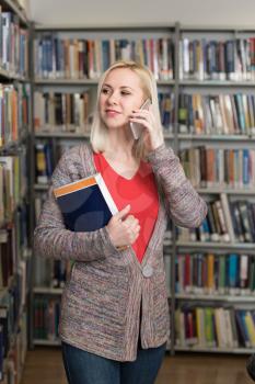 Student Talking on the Phone in Library at the University