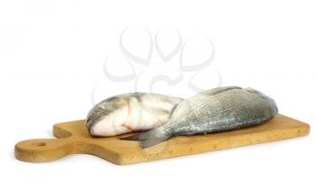 Dorado fish on wooden cutting board isolated on white