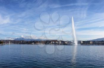 Horizontal image of Lake Geneva, Switzerland, with famous Jet d Eau fountain in background on nice sunny day                                                               