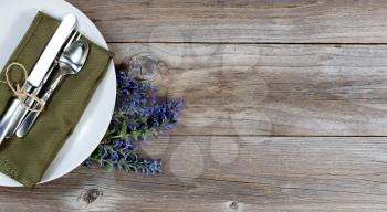 Vintage table setting with fresh flowers on rustic wood