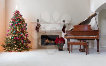 Home decorated for Christmas holiday season with glowing fireplace 