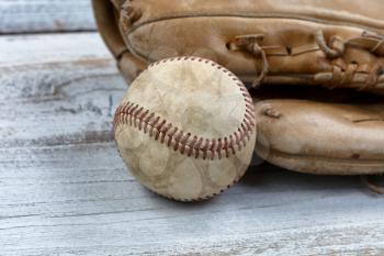 Baseball and mitt on white vintage wood 
