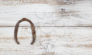 St Patricks day good luck rusty horseshoe on weathered white wood 