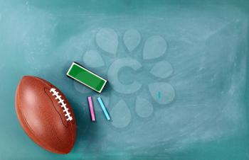 American football on cleaned chalkboard with eraser and chalk