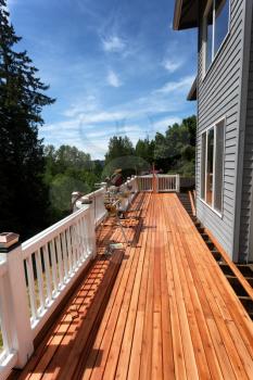 Side view of an outdoor wooden deck being completely remodeled during springtime season  