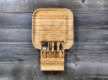 Overhead view of bamboo food server with various utensils on rustic wooden table