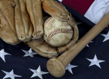 Vintage baseball equipment with American flag in background 