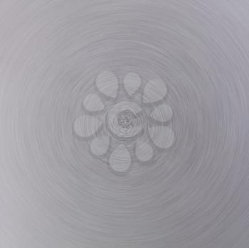 Circle of brushed aluminum metal in defocused blur motion abstract background texture   
