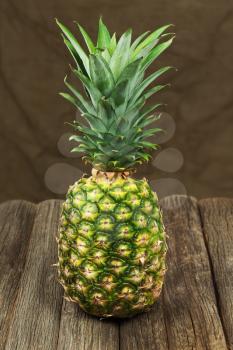 Ripe pineapple on wooden table. Closeup.