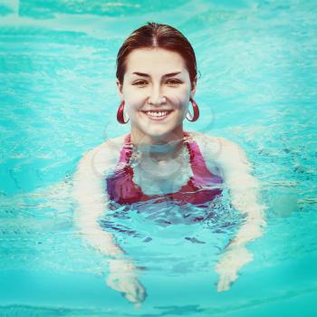 Young beautiful woman in swimming pool with retro filter effect. Closeup.