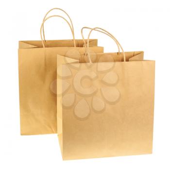 Empty brown recycled paper shopping bags isolated on white background. Side view.