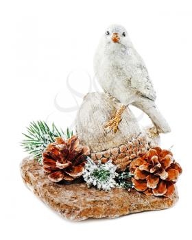 Christmas arrangement of bird on a nut with cones, pine needles and snowflakes isolated on white background
