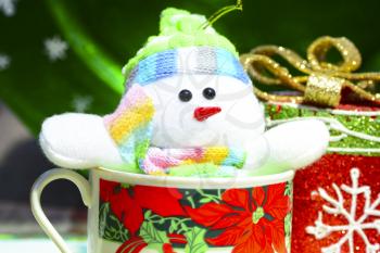 Small snowman inside a christmas cup as christmas decorations