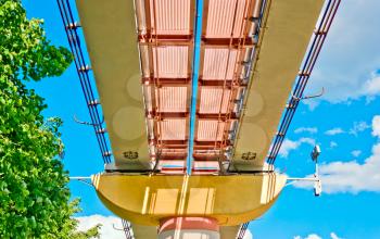 Monorail over trees on blue sky background