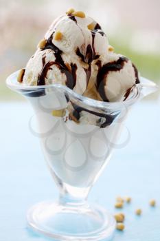 Ice cream with chocolate cream and pine nuts