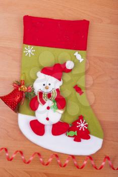 Christmas sock on the wooden background.