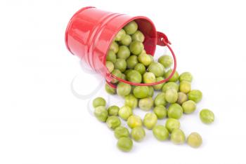 Green peas in a bucket on a white background.