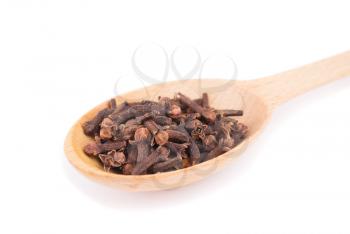 Cloves in the spoon isolated on a white background.