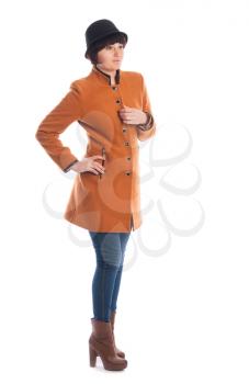 Woman posing in studio dressed in a coat.