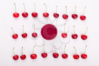 Sweet cherries and berries mug with compote. Top view .