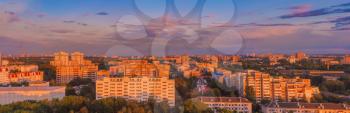 Buildings In A City In An Environment Of Green Trees At Sunset. Panoramic View Minsk - The Capital Of Belarus