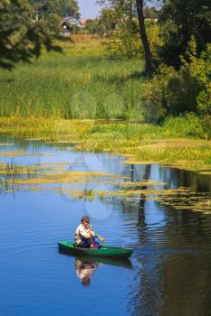 Old Man Fishing Out Of A Row Boat