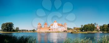 Mir, Belarus. Panoramic View Of Mir Castle Complex From Side Of Lake. Architectural Ensemble Of Feudalism, Ancient Cultural Monument, Famous Landmark In Summer Sunny Day Under Blue Sky, Copyspace.