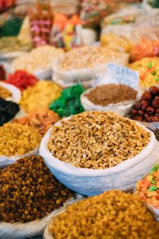 Tbilisi, Georgia. View Of Persian English Common Walnut (Juglans Regia), Succade And Dried Fruits In Bags On Showcase Of Local Food Market.