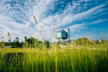Building Of  National Library Of Belarus In Minsk. Famous Symbol Of Belarusian Culture And Science. Green grass on foreground.