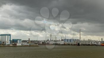 Dark clouds in the sky above the oil refineries in the dutch harbor of Rotterdam