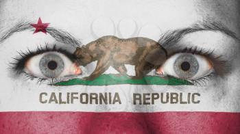 Close up of eyes. Painted face with flag of California