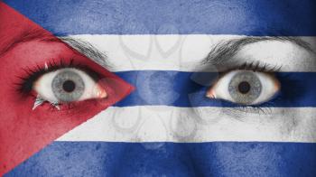 Close up of eyes. Painted face with flag of Cuba