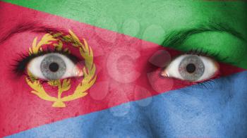 Close up of eyes. Painted face with flag of Eritrea
