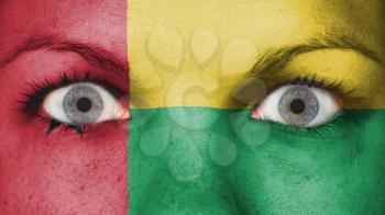 Close up of eyes. Painted face with flag of Guinea-Bissau