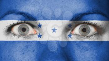 Close up of eyes. Painted face with flag of Honduras