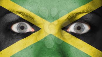 Close up of eyes. Painted face with flag of Jamaica