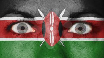 Close up of eyes. Painted face with flag of Kenya