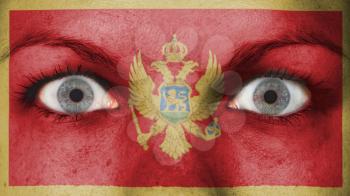 Close up of eyes. Painted face with flag of Montengro