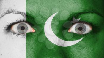 Close up of eyes. Painted face with flag of Pakistan